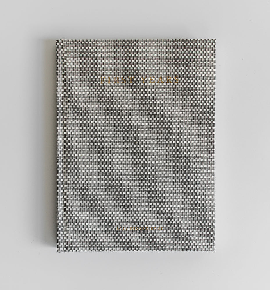 A minimal gray linen, gold foil stamped baby keepsake memory journal to record the memories, favorite things and special events of your child's first five years.